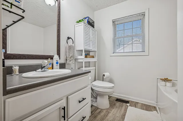 a bathroom with sink toilet and mirror