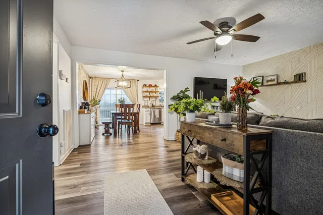 a living room with furniture and a chandelier