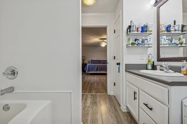 a hallway with cabinets and wooden floor