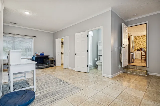 a view of a livingroom with furniture and an empty room
