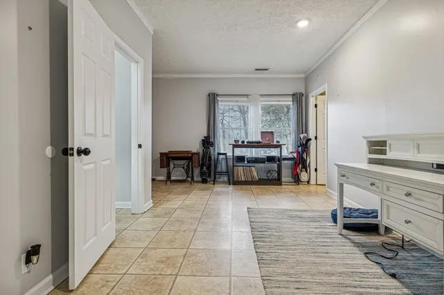 a view of a bedroom with furniture and window