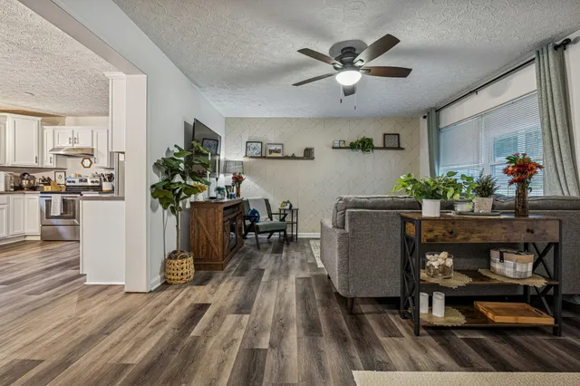 a living room with furniture and wooden floor