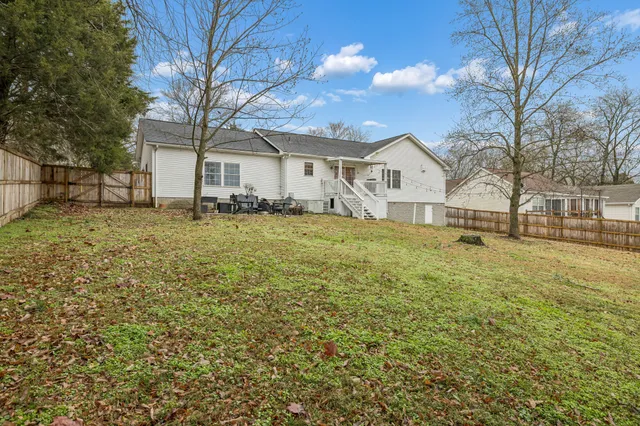 a large house with a large tree in front of it