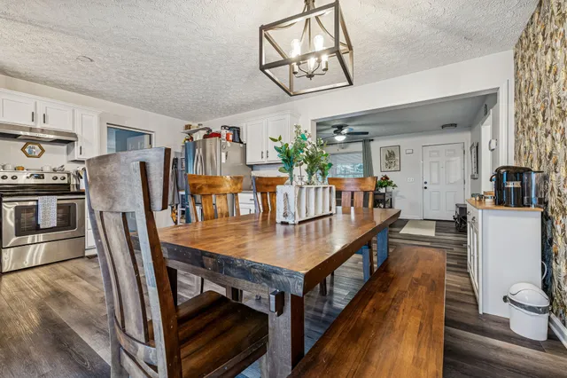 a dining room with furniture and wooden floor