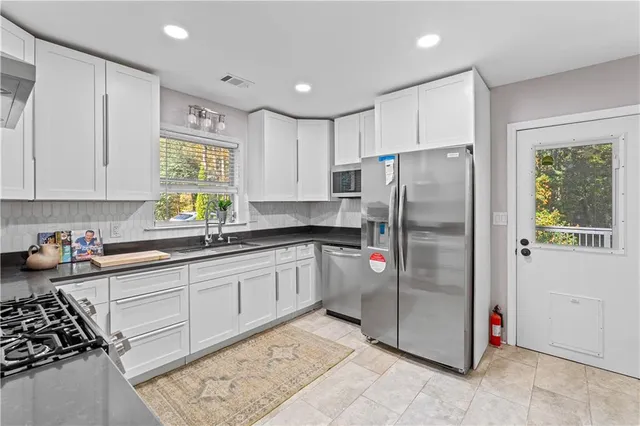 a kitchen with stainless steel appliances a stove and a refrigerator