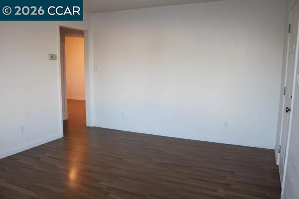 a view of an empty room and wooden floor