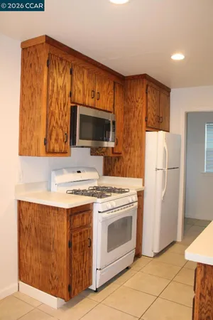 a kitchen with a stove microwave and refrigerator