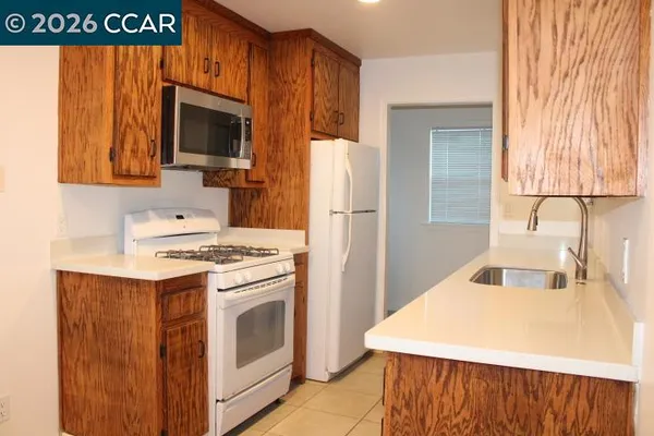 a kitchen with a stove a microwave and a refrigerator