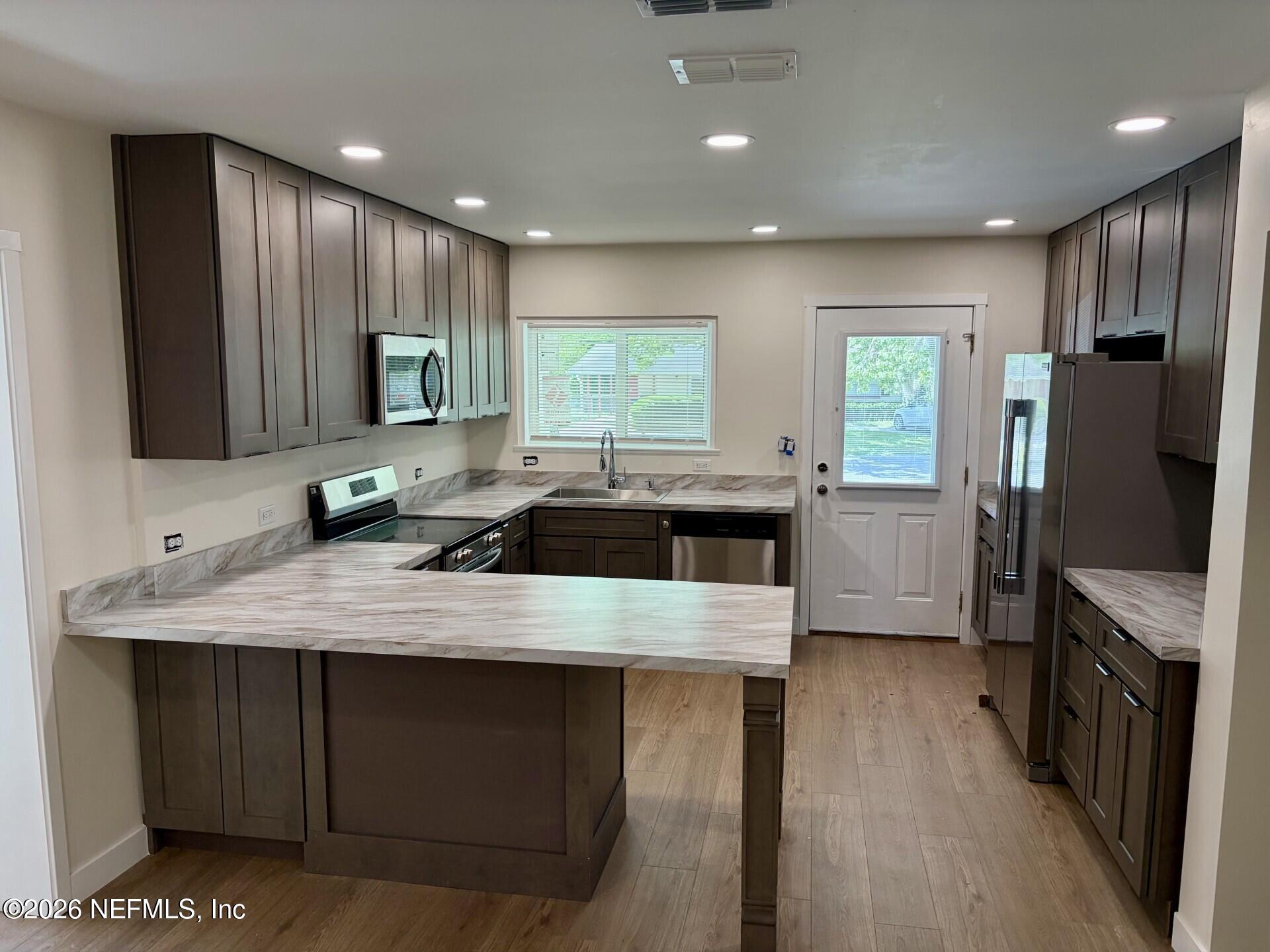 223 North Collen Road Jacksonville, FL 32218 - Photo 1 of 11 a kitchen with stainless steel appliances granite countertop a sink stove and refrigerator