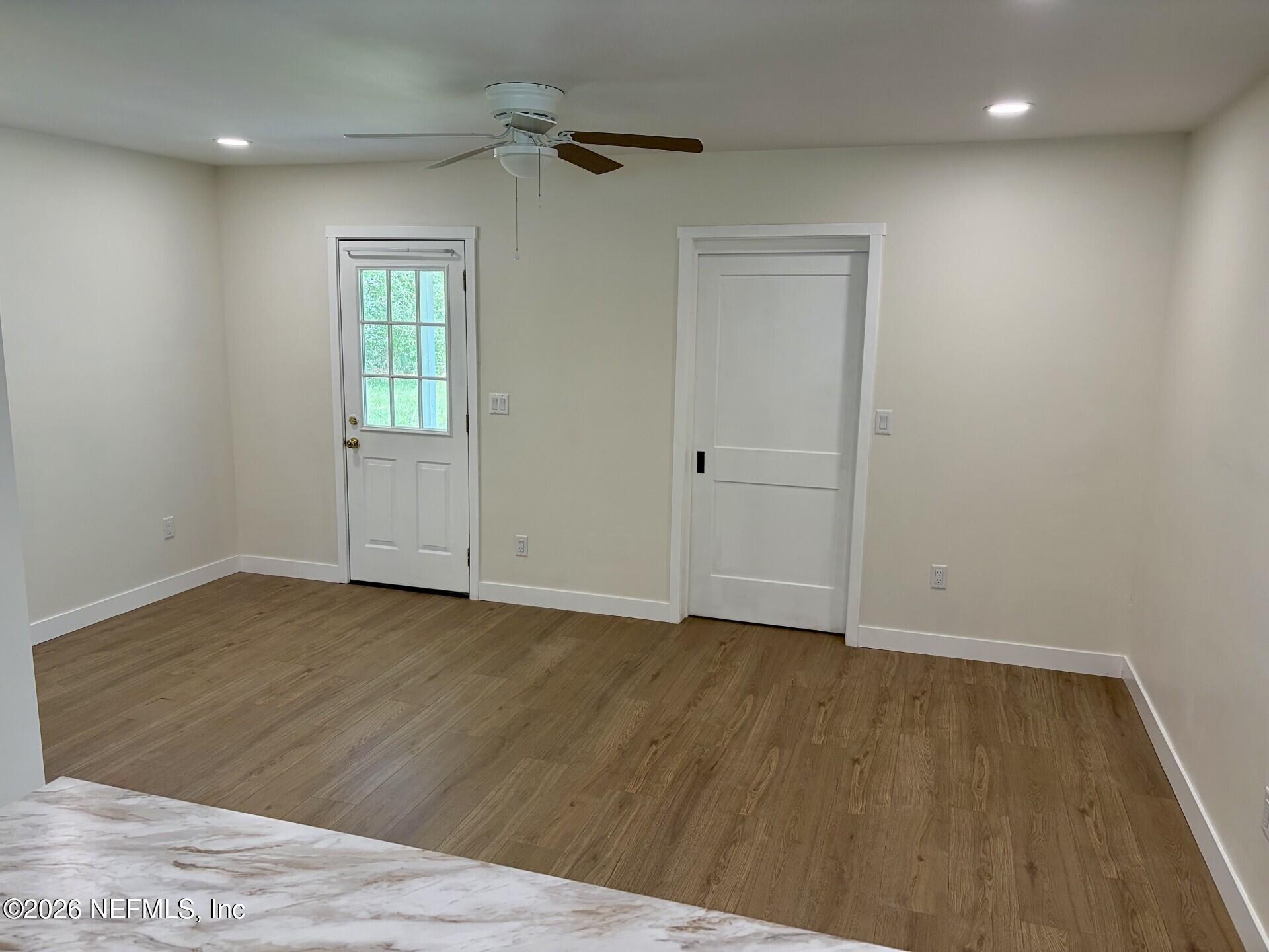 223 North Collen Road Jacksonville, FL 32218 - Photo 4 of 11 a view of an empty room with wooden floor and a window