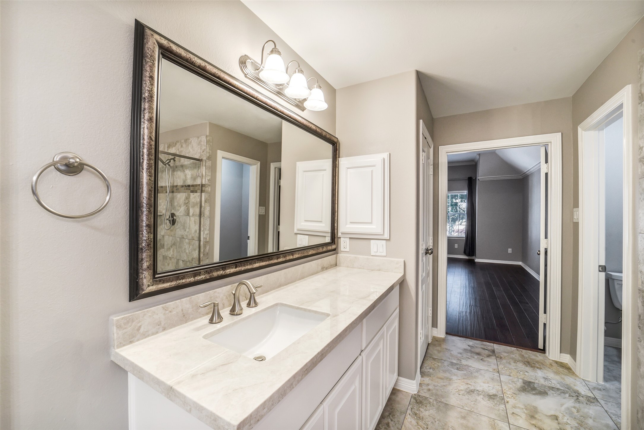 1303 Dorothy Street Houston, TX 77008 - Photo 10 of 21 The primary bath with dual vanities with sinks, large mirrors with vanity lights. Separate room for water closet.