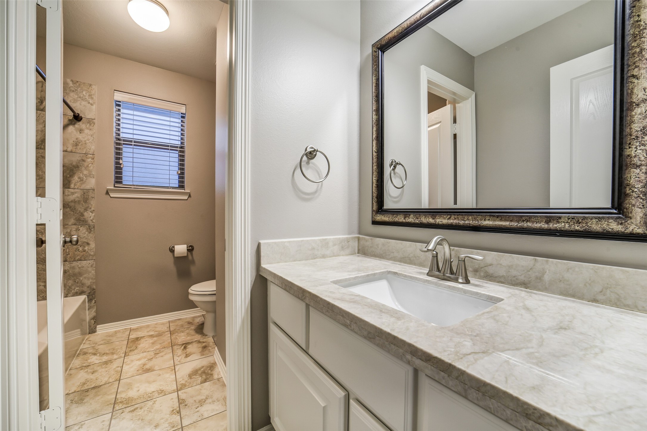 1303 Dorothy Street Houston, TX 77008 - Photo 15 of 21 Guest bathroom with hollywood style vanity with storage and separate room for tub/shower combination.