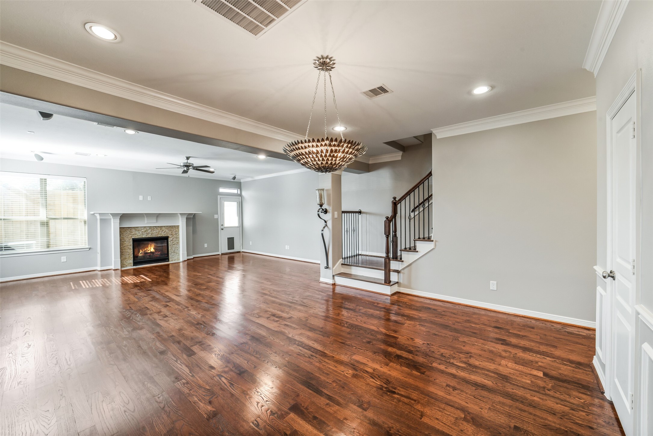 1303 Dorothy Street Houston, TX 77008 - Photo 2 of 21 A look at this open first floor living space as-is without furniture. Notice the large windows with window blinds and the door to access the backyard.