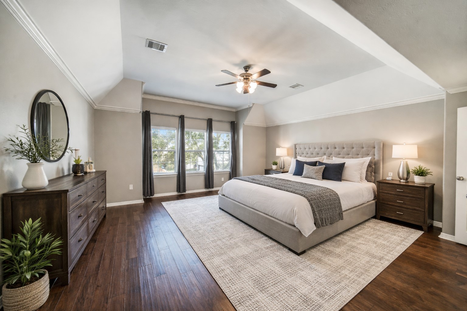 1303 Dorothy Street Houston, TX 77008 - Photo 9 of 21 Upstairs find the oversized primary bedroom with ample space for large furniture pieces. The windows come with blinds and drapes. Note this photo has been virtually staged.