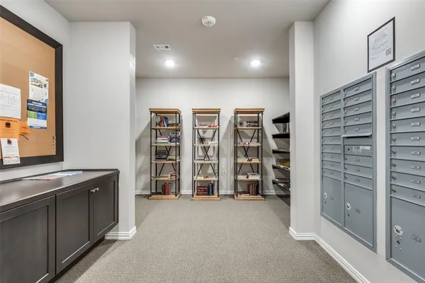 a view of an empty room with furniture and staircase