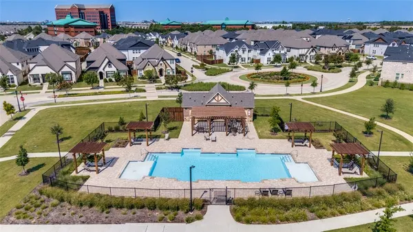 an aerial view of residential houses with outdoor space and parking