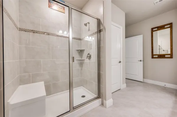 a bathroom with a glass shower door