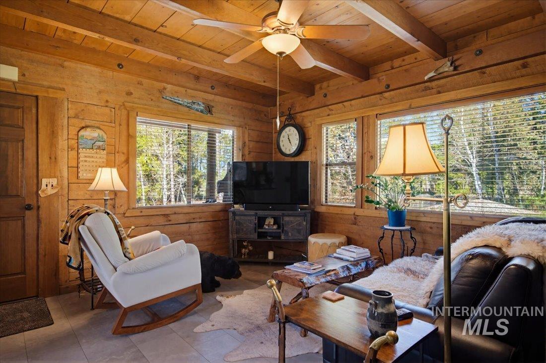 143 East Lk Frk Road McCall, ID 83638 - Photo 5 of 49 Living area featuring cozy fire and ceiling with exposed beams