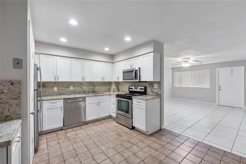 a kitchen with a sink cabinets and stainless steel appliances