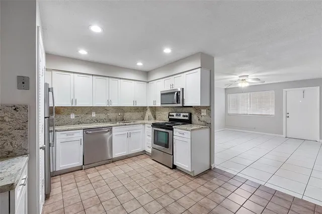 a kitchen with a sink cabinets and stainless steel appliances