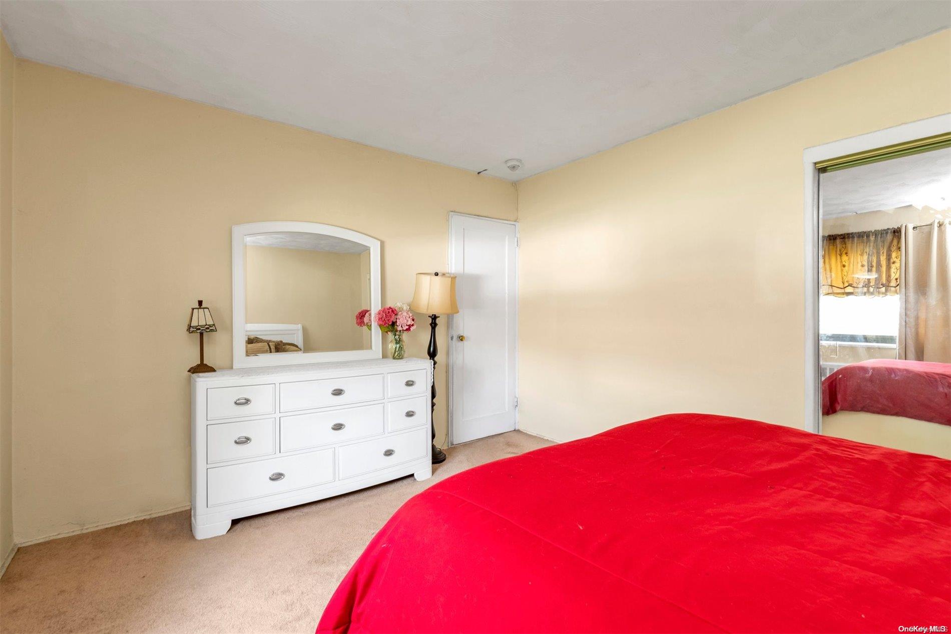 160-51 17th Avenue, Unit LOWR Queens, NY 11357 - Photo 12 of 16 a bedroom with a bed and a dresser