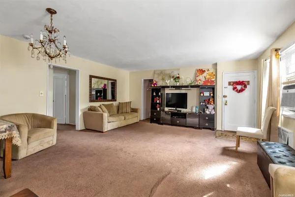 a view of a livingroom with furniture and a flat screen tv
