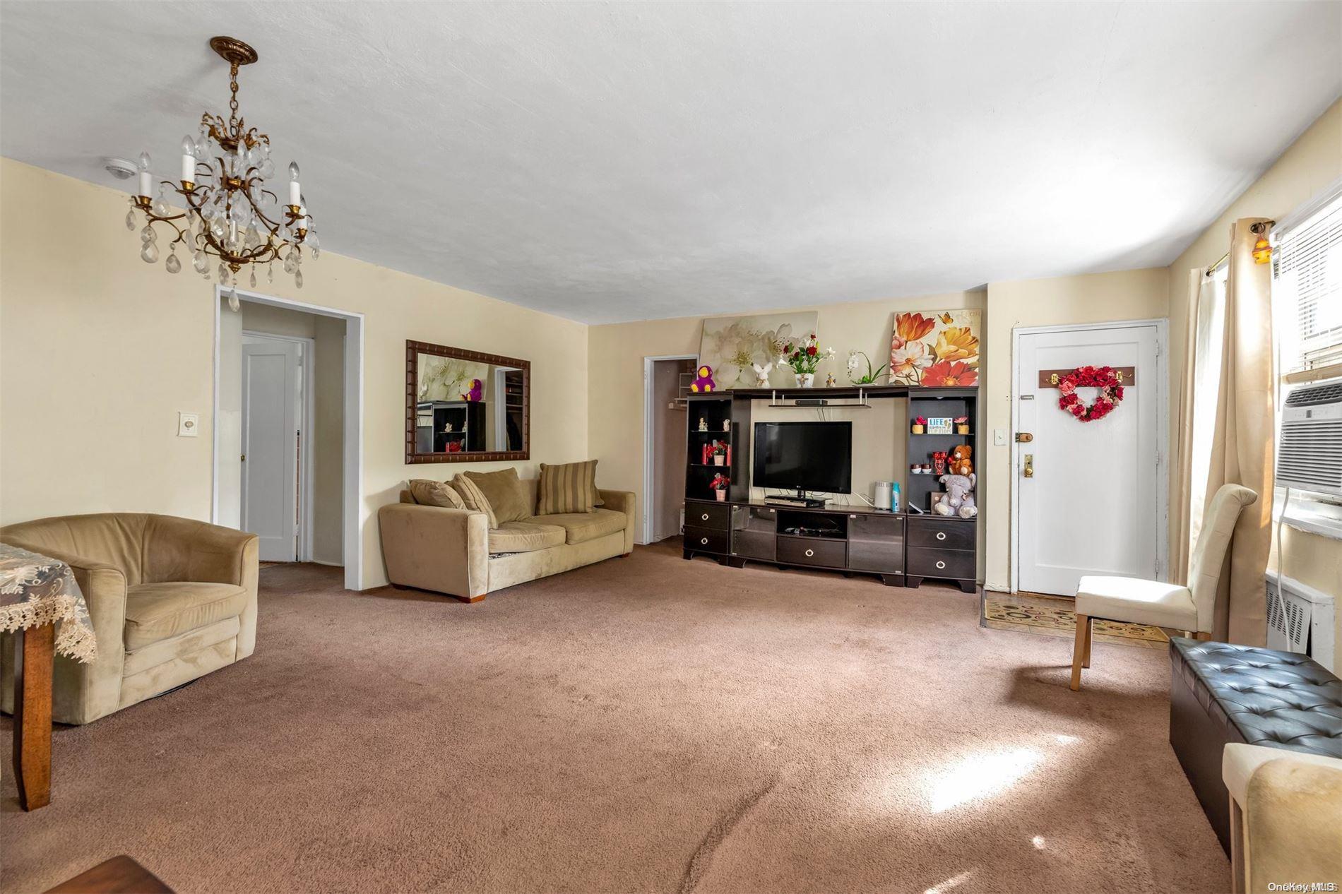 160-51 17th Avenue, Unit LOWR Queens, NY 11357 - Photo 3 of 16 a view of a livingroom with furniture and a flat screen tv