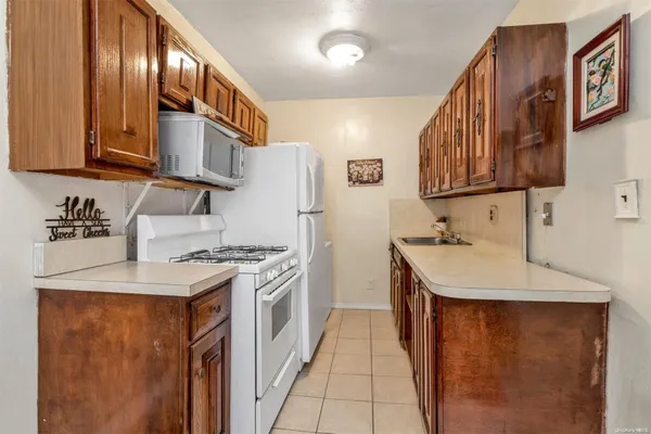 a kitchen with a sink a stove and a refrigerator
