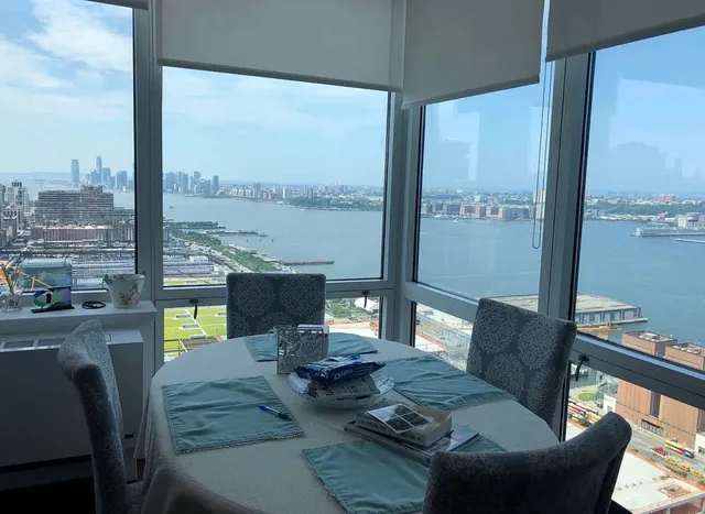 a living room with furniture and a floor to ceiling window