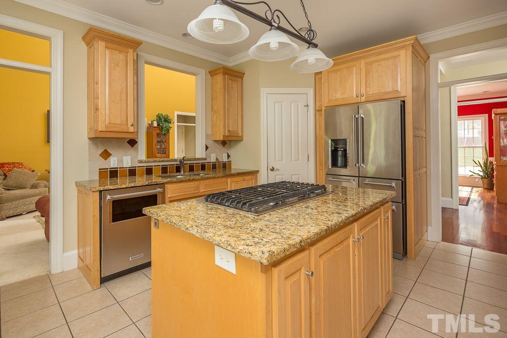 Kitchen is open to the family room, breakfast area, and has access to the screened porch.