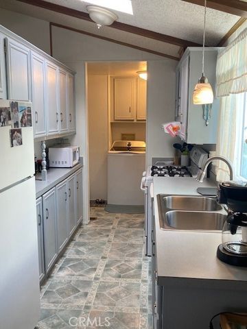a kitchen with a stove a sink and a refrigerator