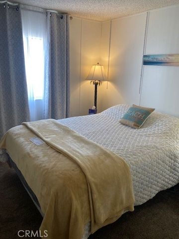 a bedroom with a bed and a lamp