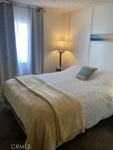 a bedroom with a bed and a lamp