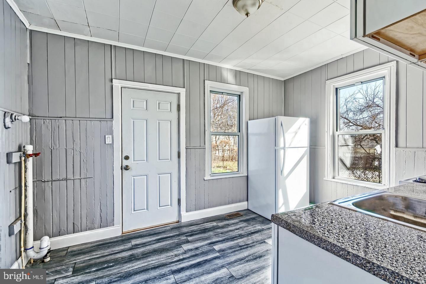 78 Walnut Street Salem, NJ 08079 - Photo 5 of 11 an empty room with windows