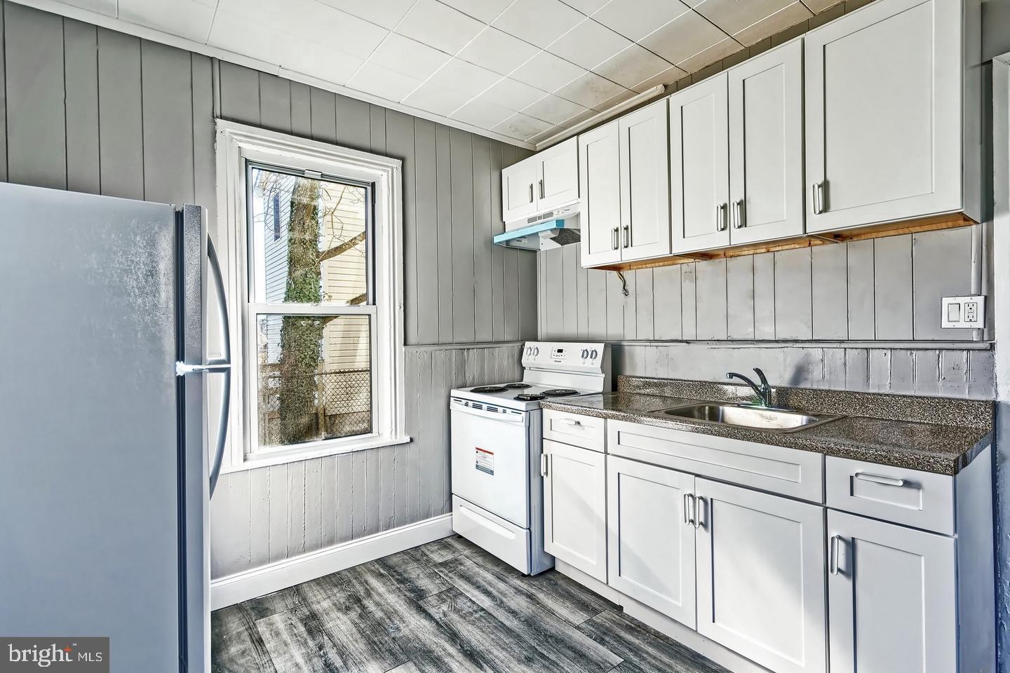 78 Walnut Street Salem, NJ 08079 - Photo 6 of 11 a kitchen with stainless steel appliances granite countertop white cabinets and window