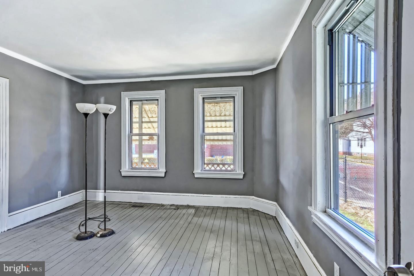 78 Walnut Street Salem, NJ 08079 - Photo 8 of 11 a view of an empty room with wooden floor and a window