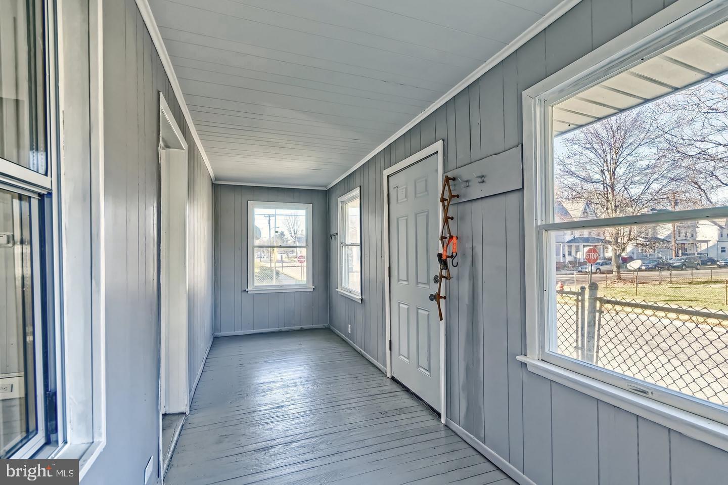 78 Walnut Street Salem, NJ 08079 - Photo 9 of 11 a view of a hallway with wooden floor and windows