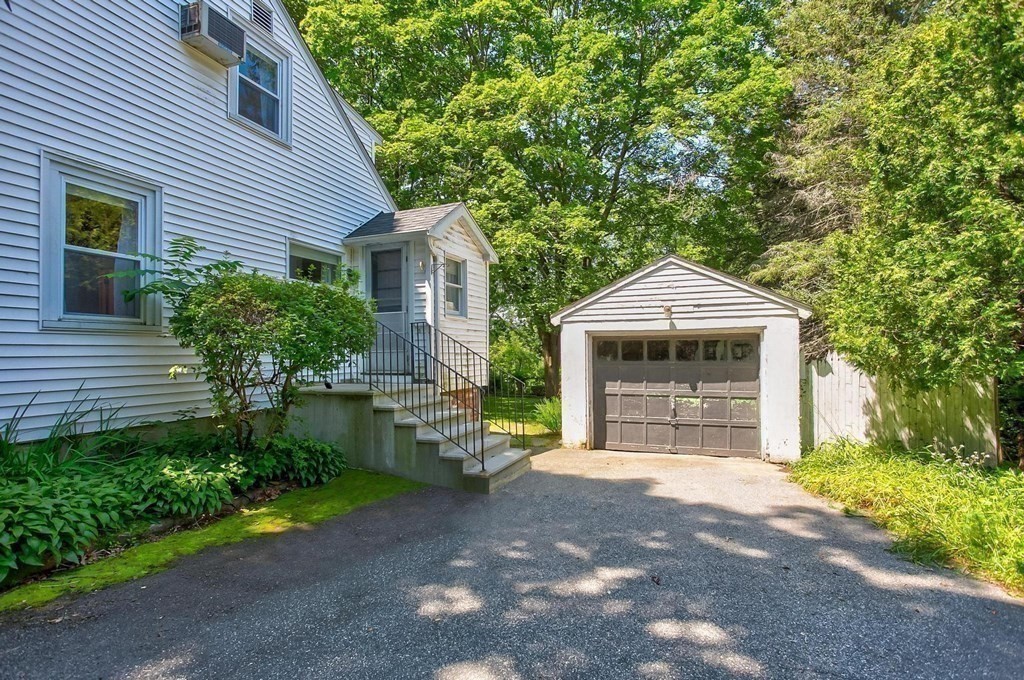 26 Shawsheen Road Bedford, MA 01730 - Photo 13 of 18 a front view of a house with a yard and garage