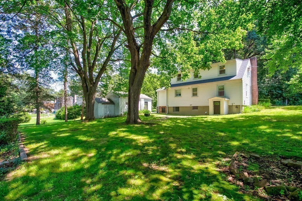 26 Shawsheen Road Bedford, MA 01730 - Photo 14 of 18 a view of a backyard with large trees and plants