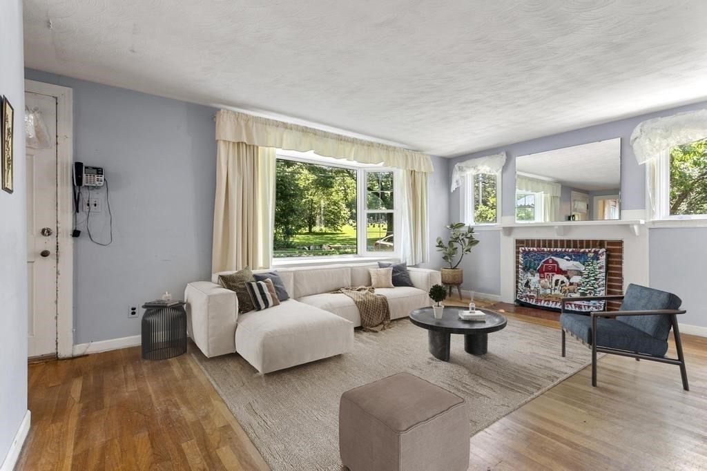 26 Shawsheen Road Bedford, MA 01730 - Photo 2 of 18 a living room with furniture and a fireplace