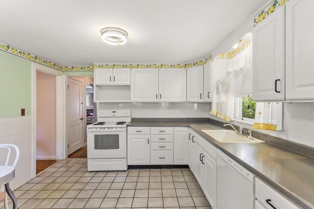 26 Shawsheen Road Bedford, MA 01730 - Photo 5 of 18 a kitchen with a white cabinets and white appliances