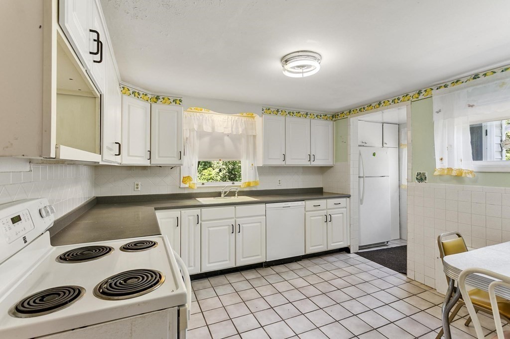 26 Shawsheen Road Bedford, MA 01730 - Photo 6 of 18 a kitchen with granite countertop white cabinets and white appliances