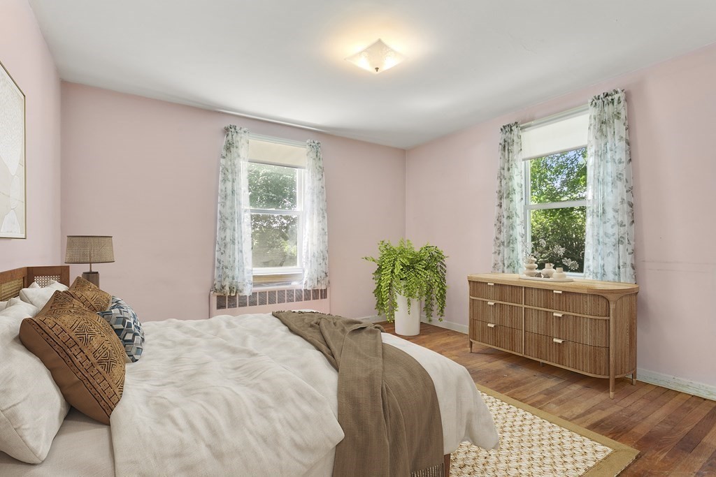 26 Shawsheen Road Bedford, MA 01730 - Photo 8 of 18 a bed sitting in a bedroom next to a window