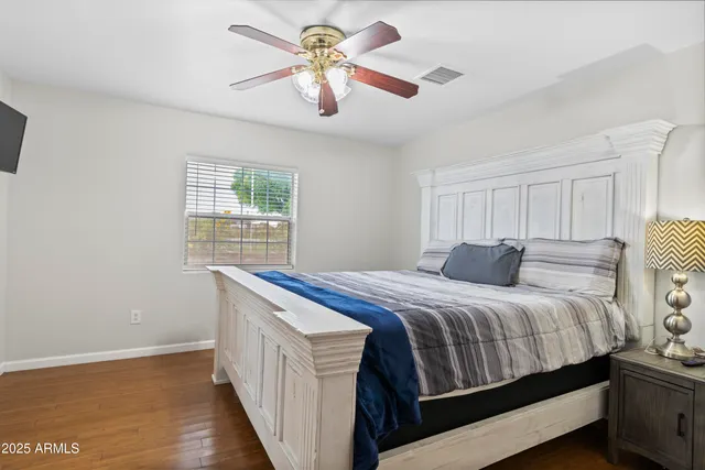 a living room with furniture kitchen view and a chandelier