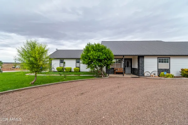 a view of a house with a backyard