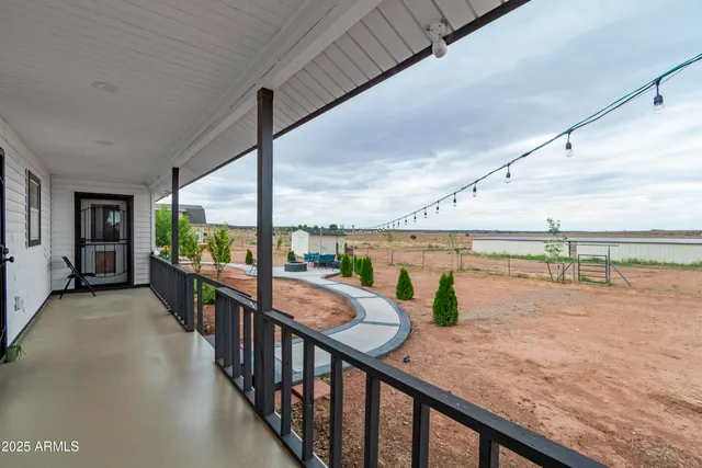 a kitchen with granite countertop a sink stainless steel appliances and white cabinets
