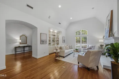 a living room with furniture a fireplace and a large window