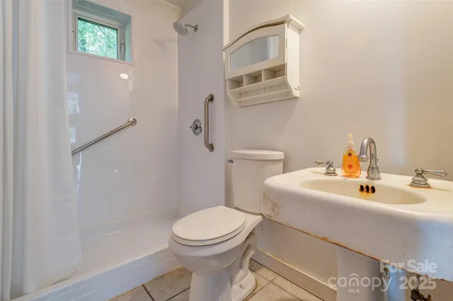 a white toilet sitting next to a bathroom sink