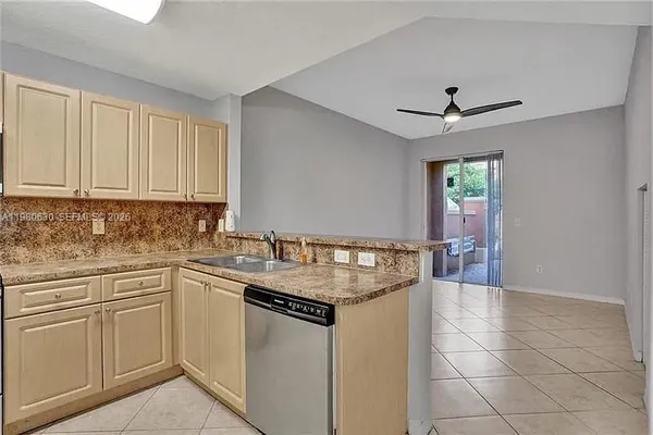 a kitchen with stainless steel appliances granite countertop a sink a stove a microwave and island