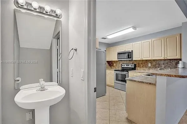 a kitchen with stainless steel appliances a sink stove and refrigerator